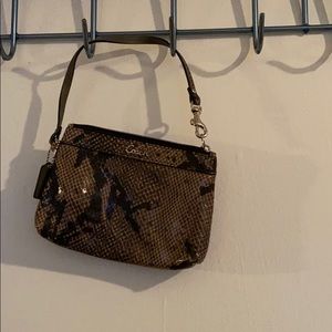 Never used coach wristlet. Snake skin print.